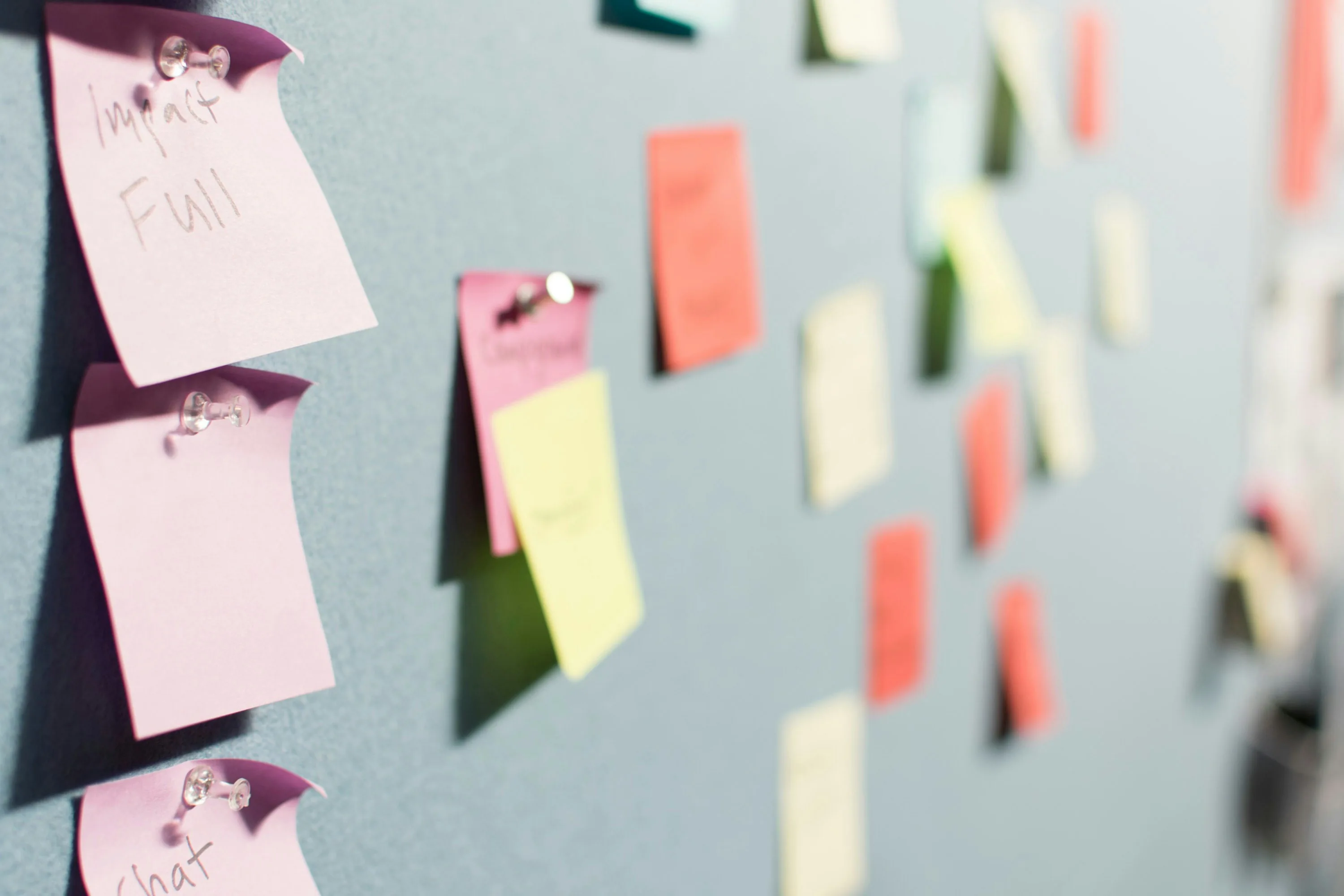 Sticky notes in different colors on a board.